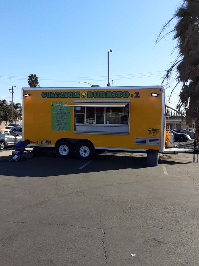The yellow Guacamole Burrito Truck parked on Mitchell Road
