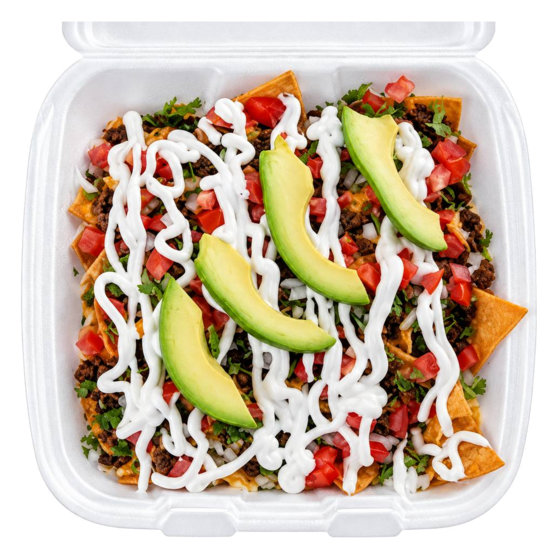 Loaded nachos with sour cream, tomato and sliced avocado