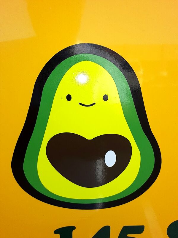 The smiling avocado mascot painted on the truck