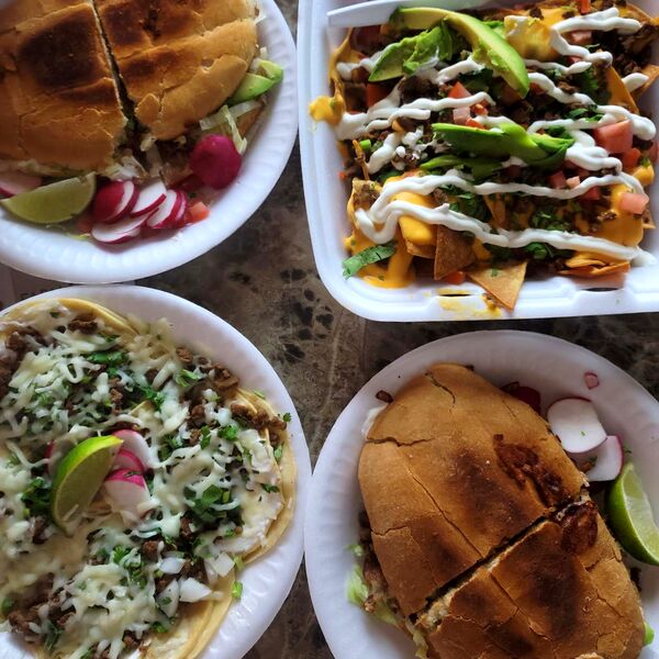 A spread of tortas, tacos and nachos on the counter