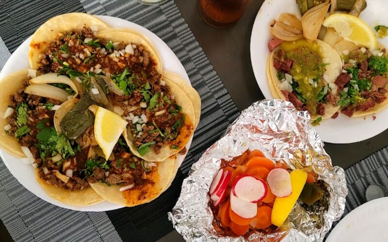 Street tacos, a burrito and radishes laid out on the table