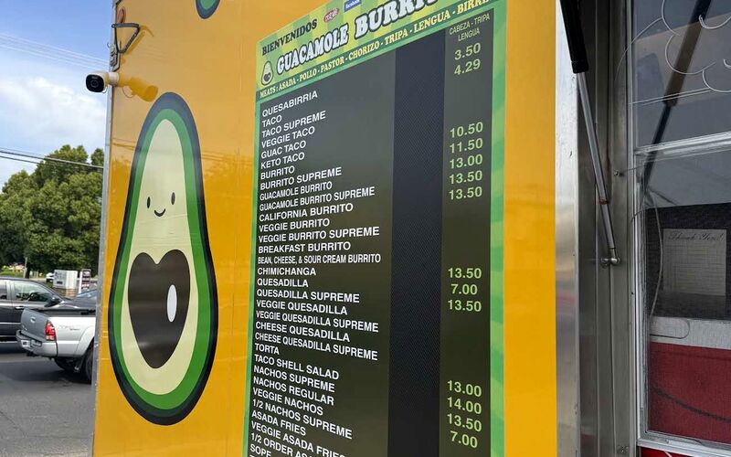 The side of the yellow truck with the avocado mascot